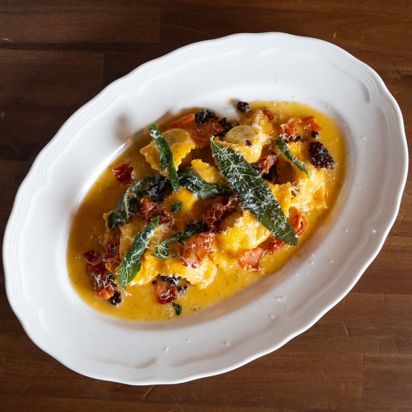 Antica Sicilia's ravioli in a rich sauce with sage, sun-dried tomatoes, and grated cheese.
