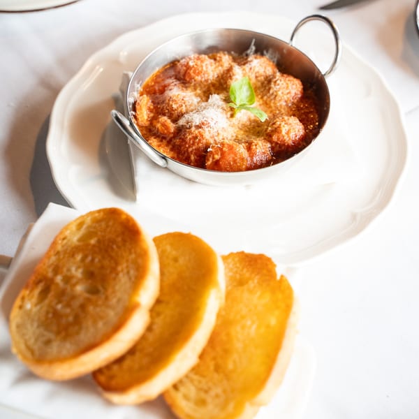 Antica Sicilia's meatballs in tomato sauce with parmesan and basil, served with toasted bread.